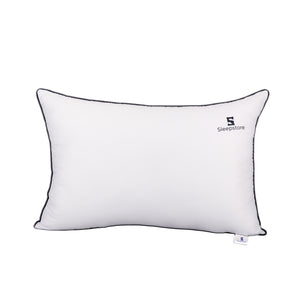 Soft white rectangular Sleepstore pillow with black piping, offering plush comfort and stylish design.