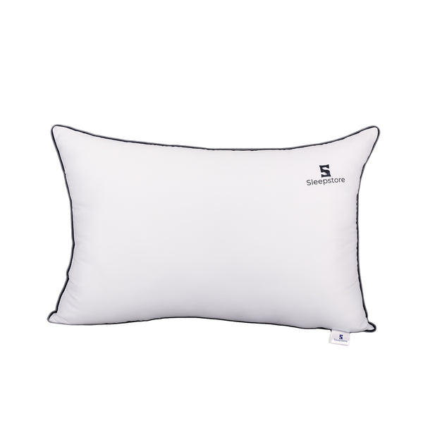 Soft white rectangular Sleepstore pillow with black piping, offering plush comfort and stylish design.
