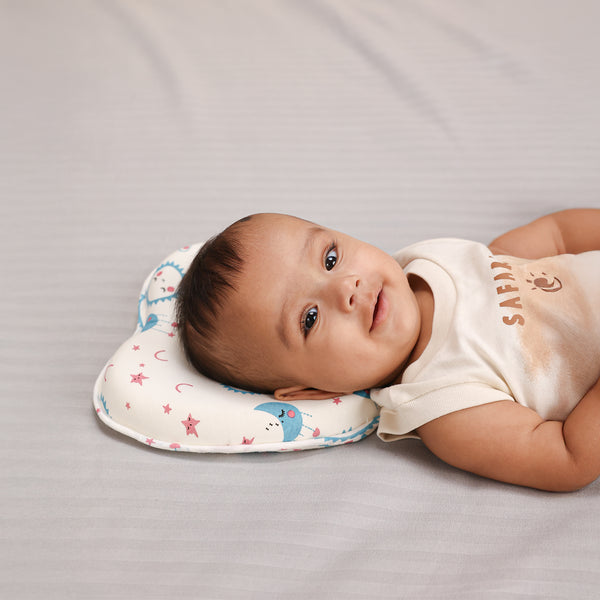 Baby lying on a soft, star-printed pillow with a breathable, hypoallergenic cover