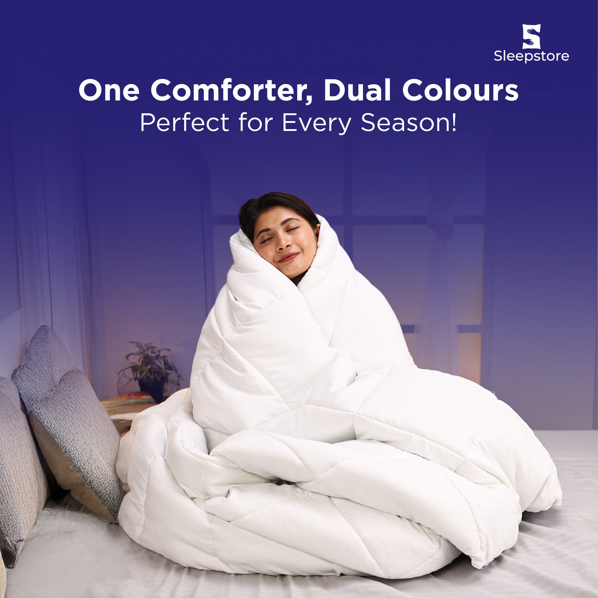 Woman wrapped in a fluffy white dual-color comforter, relaxing cozily on bed.