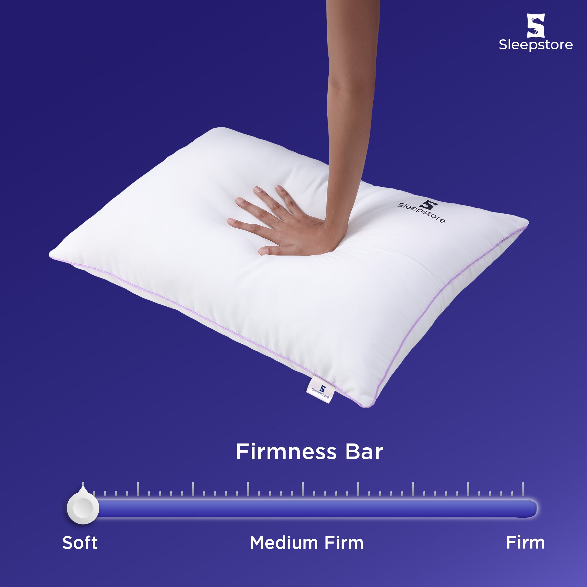 Alt text: "Hand pressing soft white Sleepstore pillow with firmness bar showing soft level"