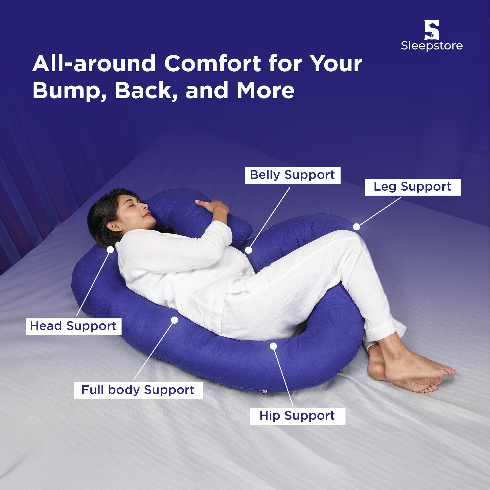 Pregnant woman resting with C-shaped pillow offering head, belly, and leg support.