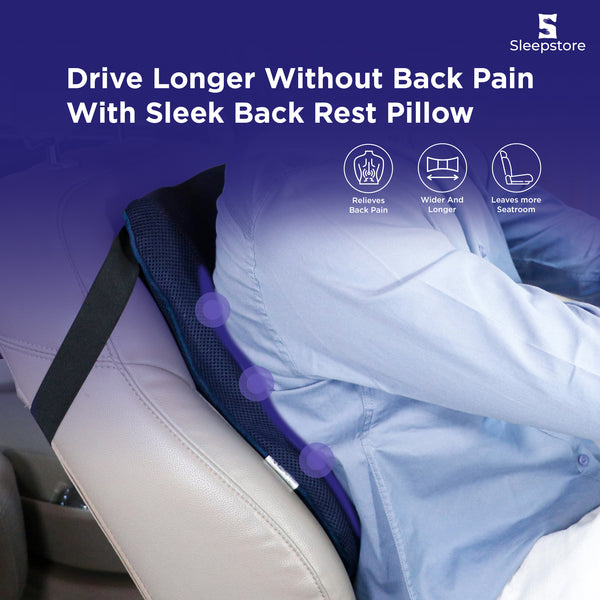 Driver using a sleek back rest pillow on car seat for back pain relief and better comfort.