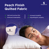 Woman sleeping on Granules Adjustable Pillow with peach finish quilted fabric for soft, breathable, durable, hypoallergenic comfort